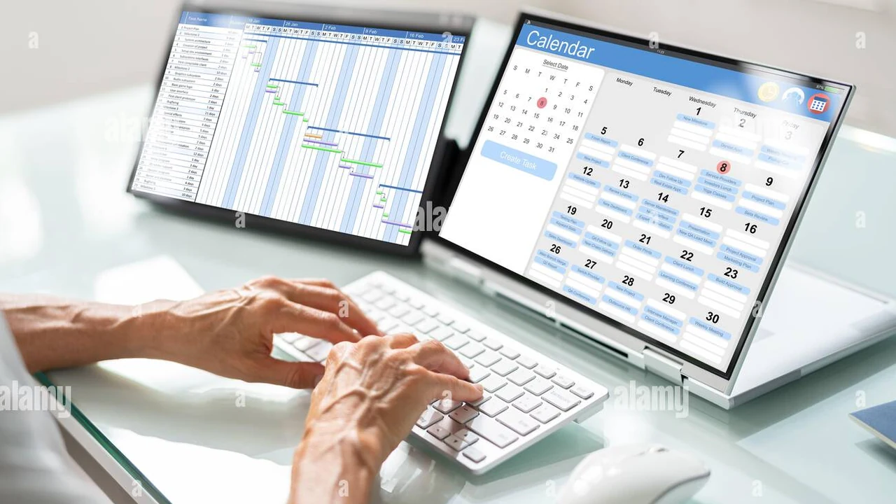 A computer screen showing an email inbox on a desk, representing inbox and calendar workflows.