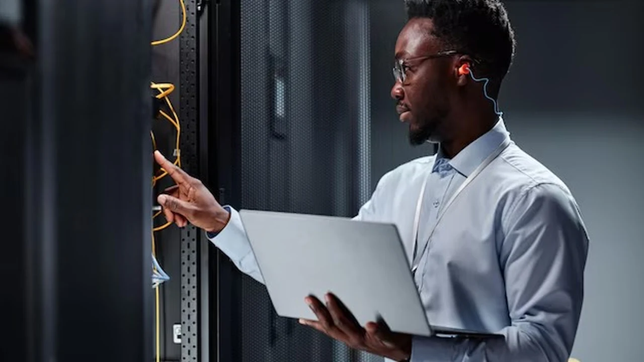 A support professional working at a computer to resolve a customer question.